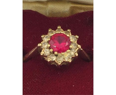 A 9ct gold ring with ruby and diamonds in a heart shaped box