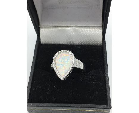 A silver and opal heart shaped ring