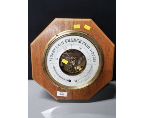 HANGING BRASS BOUND ANEROID BAROMETER ON OCTAGONAL SHAPED OAK BACKGROUND    HEIGHT 32CM