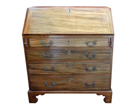 A George III mahogany bureau, the hinged fall enclosing a fitted interior with star and arch inlaid central cupboard and 'sec