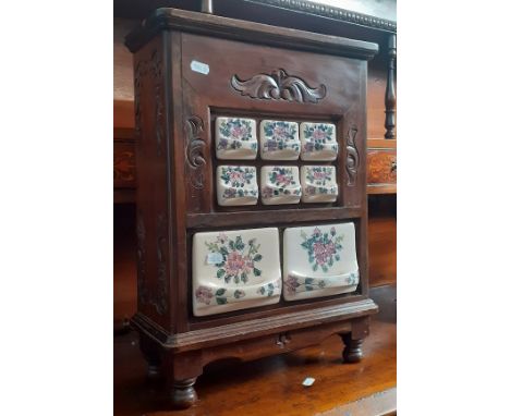 A Dutch mahogany and ceramic spice rack.