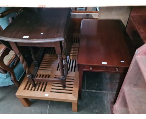 Three pieces of furniture; a modern light wood coffee table, an oak drop leaf table and a mahogany drop leaf table. 