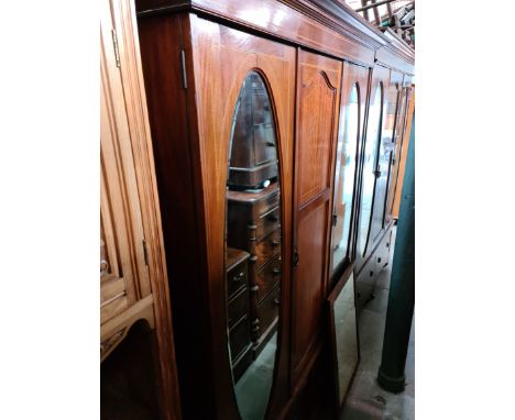 An Edwardian inlaid mahogany wardrobe, width 163cm and an oak framed mirror. 