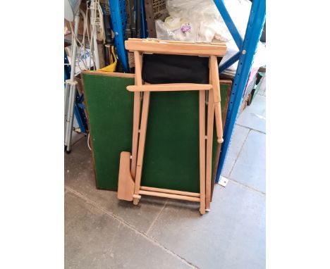 A high folding director's chair and a card table.
