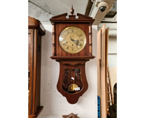 A reproduction drop dial wall clock, signed 'Reguladora', length 78cm. 