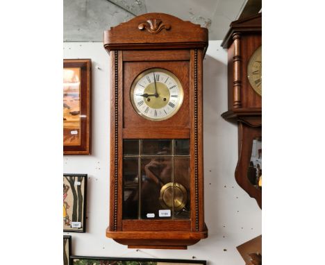 An oak wall clock. 