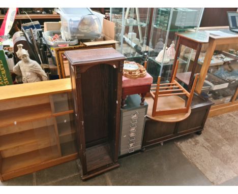 7 pieces of furniture and a clock to include a glazed bookcase, oak bookcase, chest, metal drawer unit and a coffee table etc