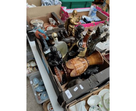 A box of ornaments including brass and spelter figures, cast metal doorstop, Bells whiskey flask, wooden vase etc. 