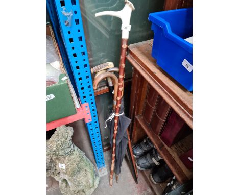 A bundle of silver banded walking sticks, horn handled walking stick and a vintage umberella 