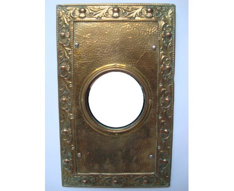 An early 20th Century poss Scottish Arts and Crafts circular porthole wall mirror with rectangular hammered brass surround an