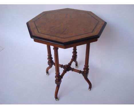 A Victorian burr walnut and ebonised octagonal low occasional table, the crossbanded and strung top with moulded edge raised 