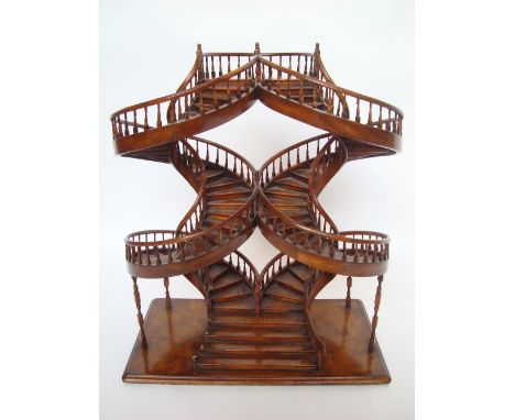 A walnut architectural scale model of double spiral staircase, 68.5cm high.  Purchased from Harrods, small loss to balustrade