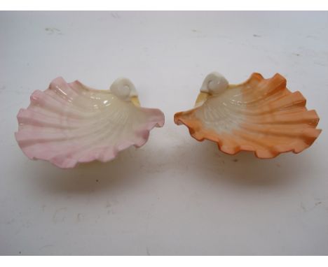 A pair of Royal Worcester scallop shell pattern nut dishes, each fashioned with pink glazes on three stud feet, model 172 (2)