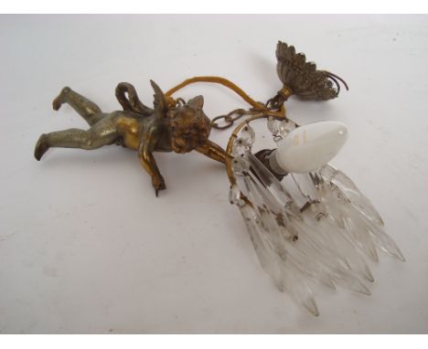 An Edwardian gilt spelter cherub ceiling light, suspended on a chain with foliate boss, the shade hung with glass drops.