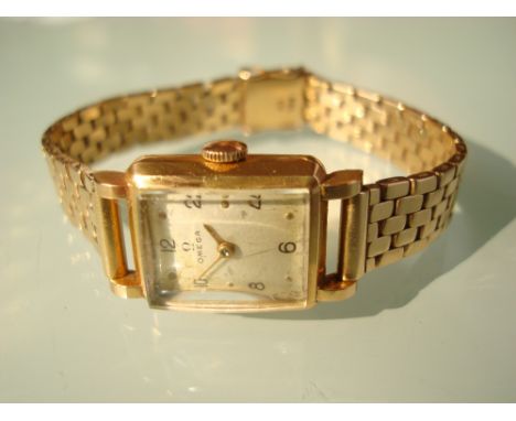Ladies 18 carat gold Omega wristwatch, the rectangular silvered dial with Arabic numerals and gilt hands, 15 jewel manual win