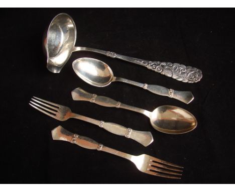 A mid 20th Century Danish pair of table forks and tablespoons marked for Copenhagen by Christian F. Heise with hammered finis