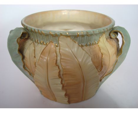 A Royal Worcester blush porcelain three handled jardiniere, pattern 1947.  Moulded with leaves against a basket weave ground,