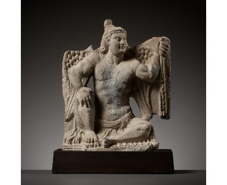 A GRAY SCHIST FIGURE OF A WINGED ATLAS, ANCIENT REGION OF GANDHARA, 3RD - 4TH CENTURYThe atlant squats with his right leg rai