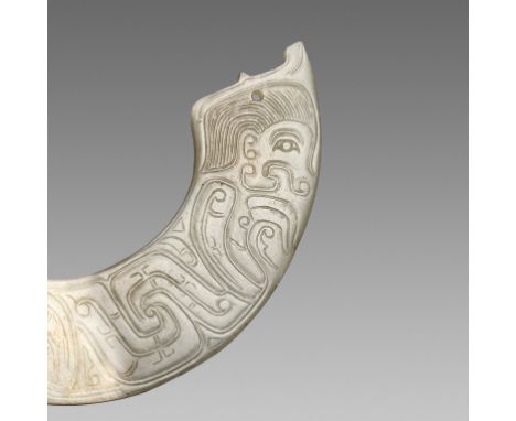 A SMALL PALE CELADON JADE 'HUMAN FIGURE' ORNAMENT, HUANG, WESTERN ZHOU DYNASTYChina, 1100-771 BC. The arched ornament is neat