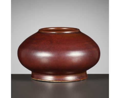 AN IRON-RUST GLAZED WATERPOT, QING DYNASTY  China, 18th-19th century. Of compressed globular form with lipped rim, supported 