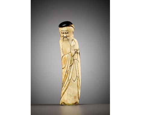 AN IVORY FIGURE OF SHOULAO, MING DYNASTYChina, 16th-17th century. The standing Immortal carved from the curved tusk holding a
