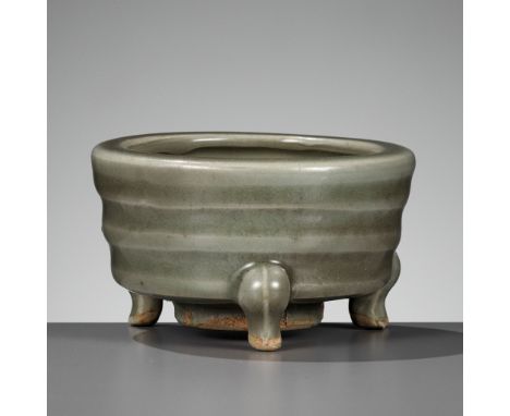 A SMALL LONGQUAN CELADON TRIPOD CENSER, LIAN, SONG DYNASTYChina, 960-1279. The cylindrical body rising from three short feet 