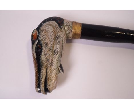 A walking stick with a Badger's head knop