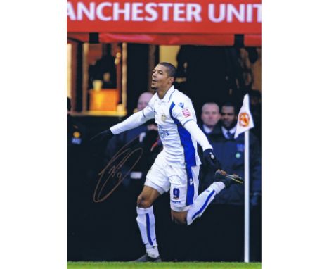 Autographed JERMAINE BECKFORD 16 x 12 photo - Col, depicting the Leeds United striker running away in celebration after scori