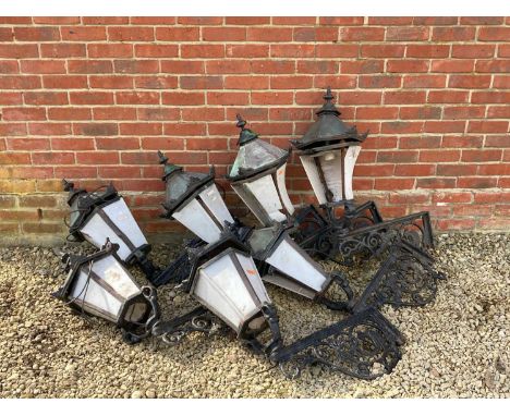 Seven cast iron wall mounted Victorian lanterns the cast iron with bird and foliate scrolling decoration, acanthus leaf decor
