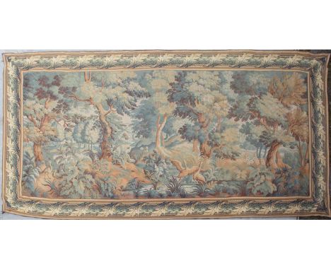A mid to late 20th century Flemish machine made tapestry with a banded border and decorated with trees and foliage, 440cm x 2