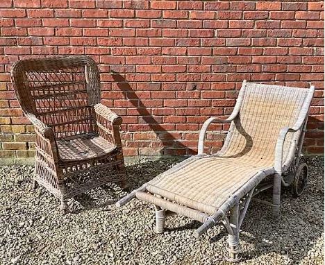 A wicker sun lounger with arm rests on wheels with carrying handles at the foot end, 152cm long x 55cm wide x seat height app