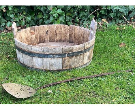 A coopered iron bound whey trough 51cm diameter x 17cm high together with an antique brass pierced skimmer with wrought iron 