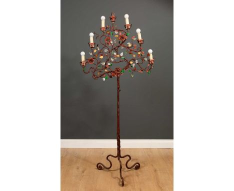 A mid 20th century painted wrought and pressed metal seven branch floor light of naturalistic vine form, 80cm wide x 172cm hi