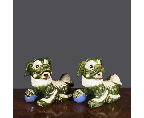 Two similar Chinese ceramic dogs of fo with green and white painted and engraved decoration, 28cm wide x 15cm deep x 25cm hig