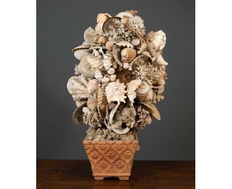 A shell sculpture consisting of a variety of shells and coral placed in a square terracotta pot, 86cm high together with a gr