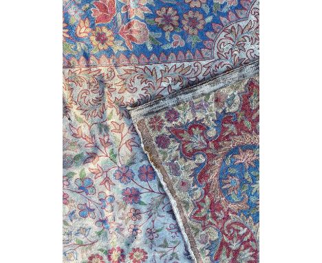 A Kashmiri chainstitch tapestry rug or wall hanging the all over floral decoration on white ground within beige border, 179cm