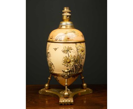 A Victorian aesthetic movement lamp, the porcelain floral base decorated with yellow flowers and bees, on a brass tripod stan