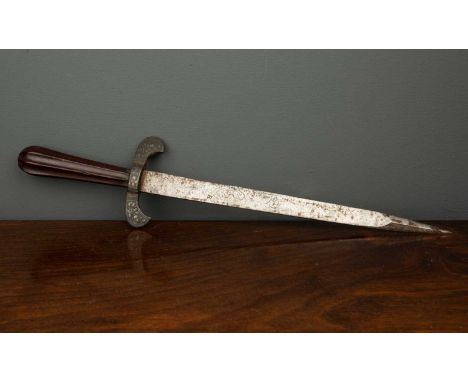 A Quillon dagger, possibly early 17th century, with fluted tapering fruitwood grip, curved quillons with embossed floral deco