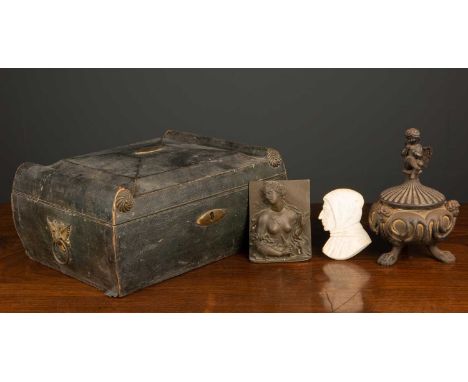 A cast metal inkwell with cherub finial on three clawed feet and ceramic liner, 18cm high together with a leather brass mount