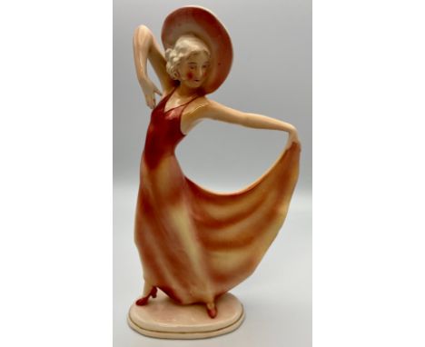 German Art Deco "Katshute" ceramic figure of woman in hat holding hem of pink dress, on oblong base, height 28.5cm, factory m