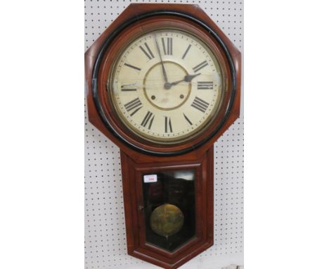 A striking American wall clock by The Ansonia Clock Company New York in a mahogany case with a painted black trim. The painte