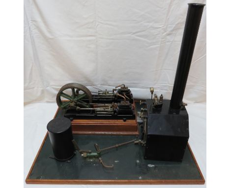 A model of a 'Victoria' double cylinder steam engine, diameter of flywheel about 18cm, mounted on a wooden base (53.5cm x 67c