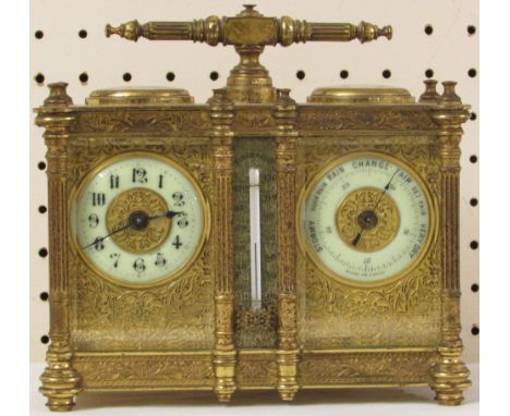 A 19th century heavily chased brass and gilded bevelled glass combination carriage clock housing an eight day clock movement,