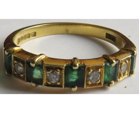 18 carat gold ring set with a row of five small emeralds and four small diamonds, the emeralds each about 3mm x 2mm,  the rou