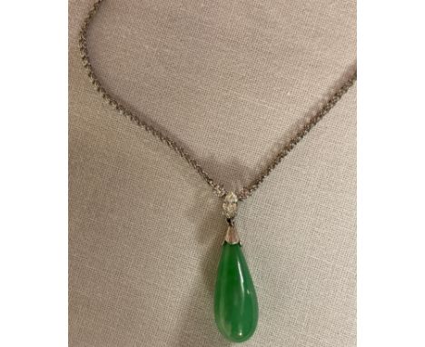 Tear drop pendant of a green jade type stone mounted with a marquise cut diamond (about 4mm x 2mm), and two brilliant cut dia