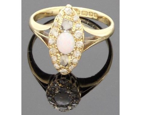 18 carat gold opal and diamond ring, the oval setting with an opal (5.5mm x 4mm) centrally between two small irregular old cu