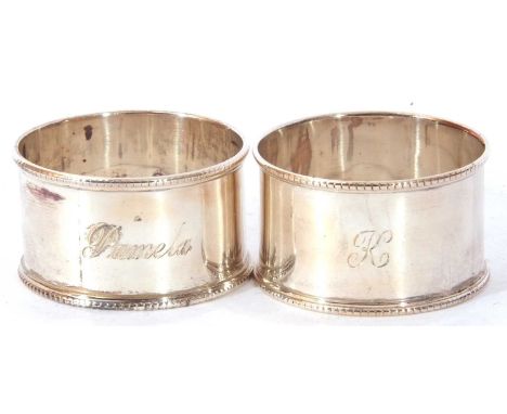 Case containing two silver serviette ring, one London 1894, the other with marks rubbed (2)