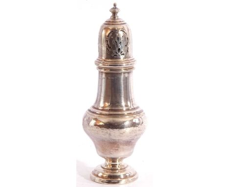 George V silver caster of baluster form, the pierced pull off lid with urn finial, raised on a stepped circular foot, Chester