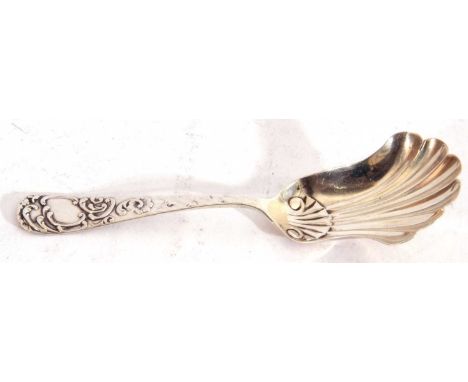 Victorian silver shovel caddy spoon, the long handle decorated with a scroll border and vacant cartouche to the terminal, the