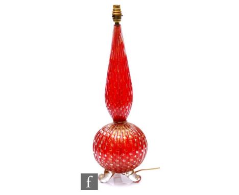 A post war Murano glass lamp base of globe and swollen shaft form, attributed to Barovier and Toso, the red core with interna